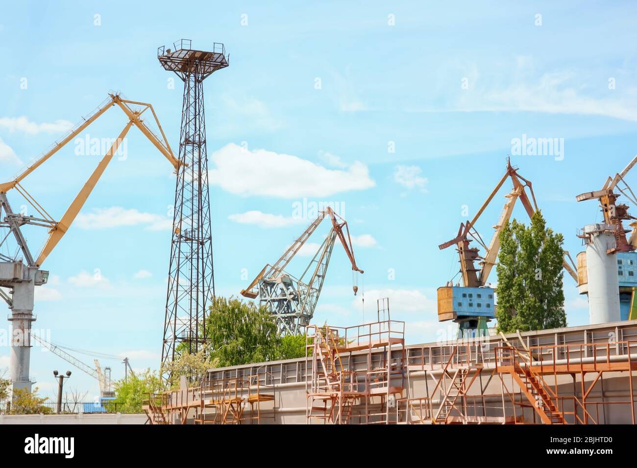 Hoisting cranes in shipyard Stock Photo