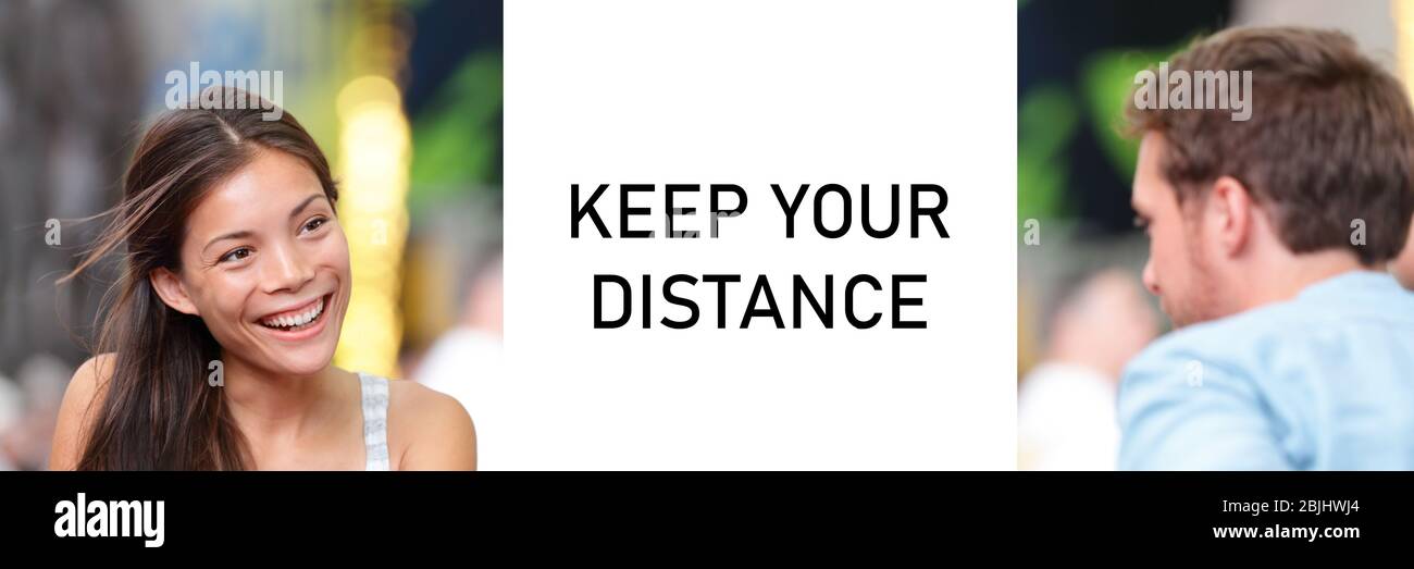 KEEP YOUR DISTANCE Covid-19 warning sign for people meeting talking together panoramic banner. Asian woman speaking to man. Stock Photo