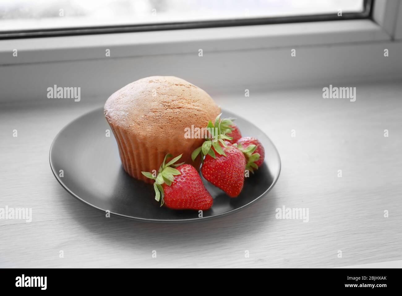 Delicious muffin on windowsill Stock Photo