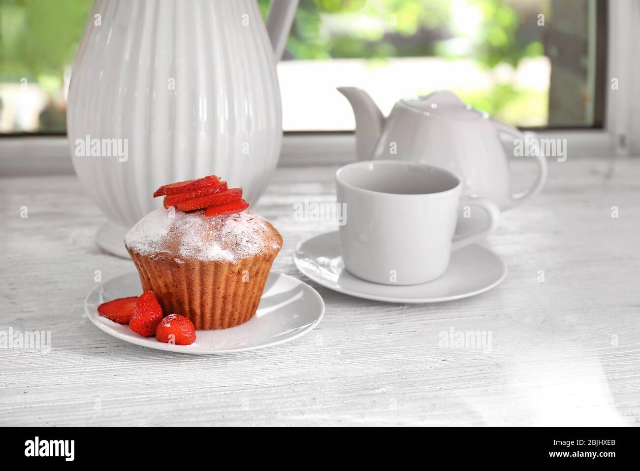 Delicious muffin on windowsill Stock Photo