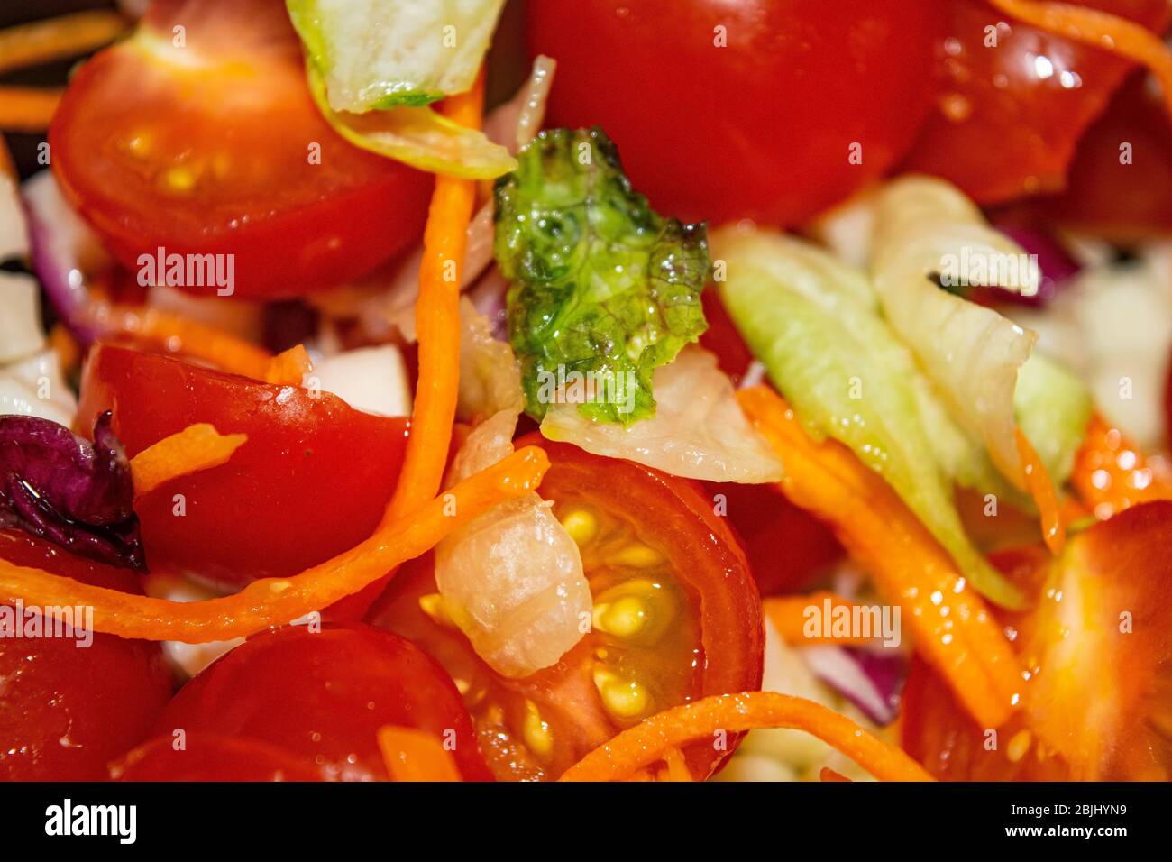 Vegetable salad sliced tomatoes, onions, lettuce, carrots and beets. Close up. Healthy food and fitness diet Stock Photo
