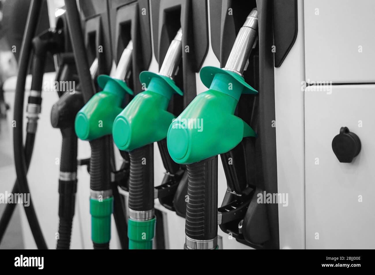 Fuelling nozzles at gas station Stock Photo Alamy