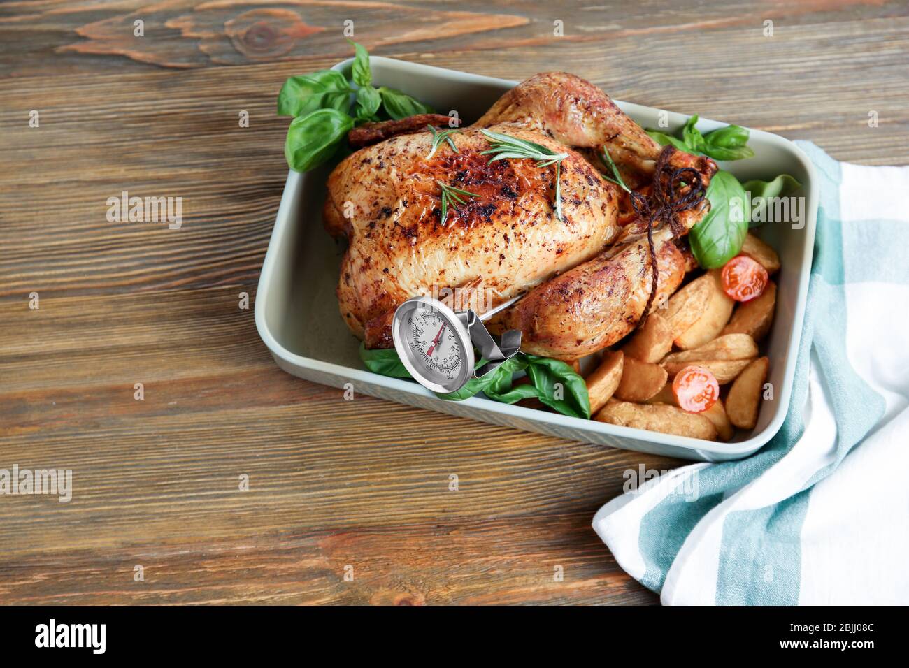 Golden roasted turkey with meat thermometer on table Stock Photo
