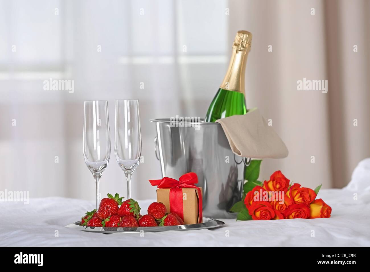 Romantic composition with champagne and strawberry on bed. Honeymoon  concept Stock Photo - Alamy