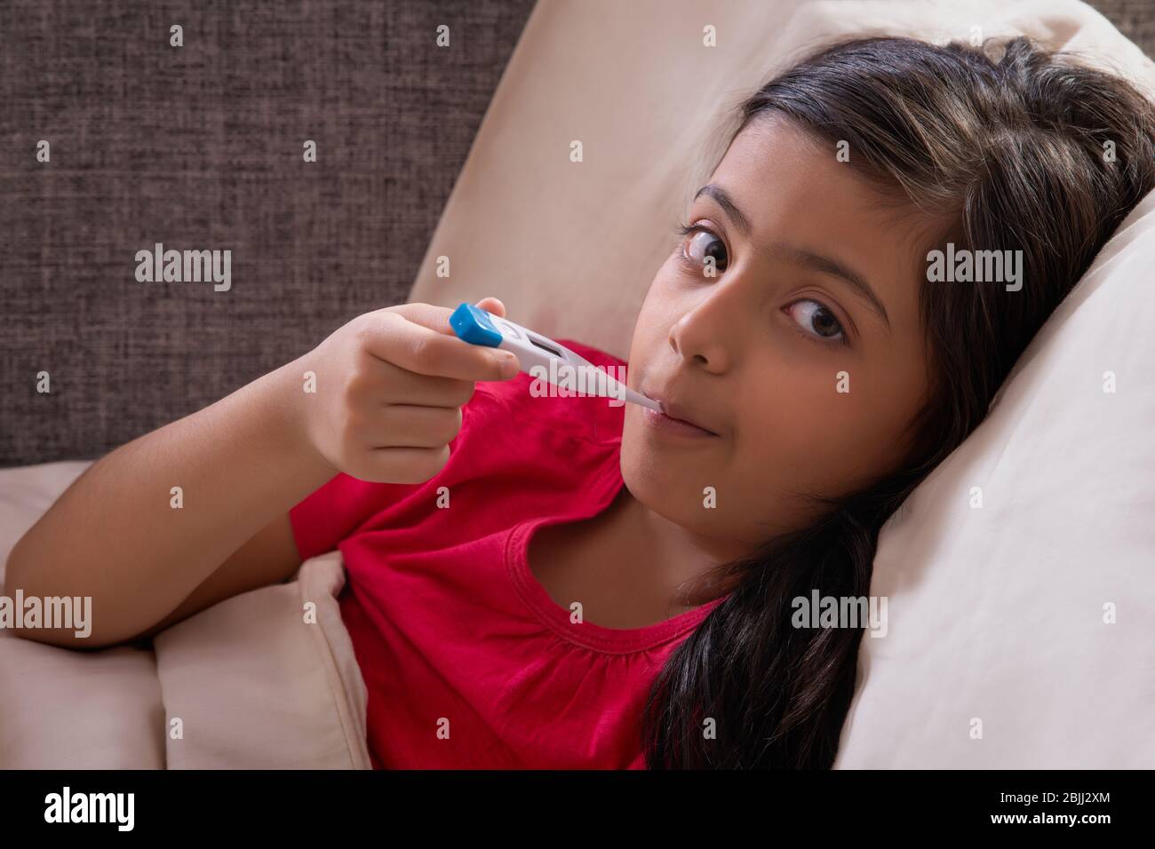 Girl lying on sofa hi-res stock photography and images - Alamy