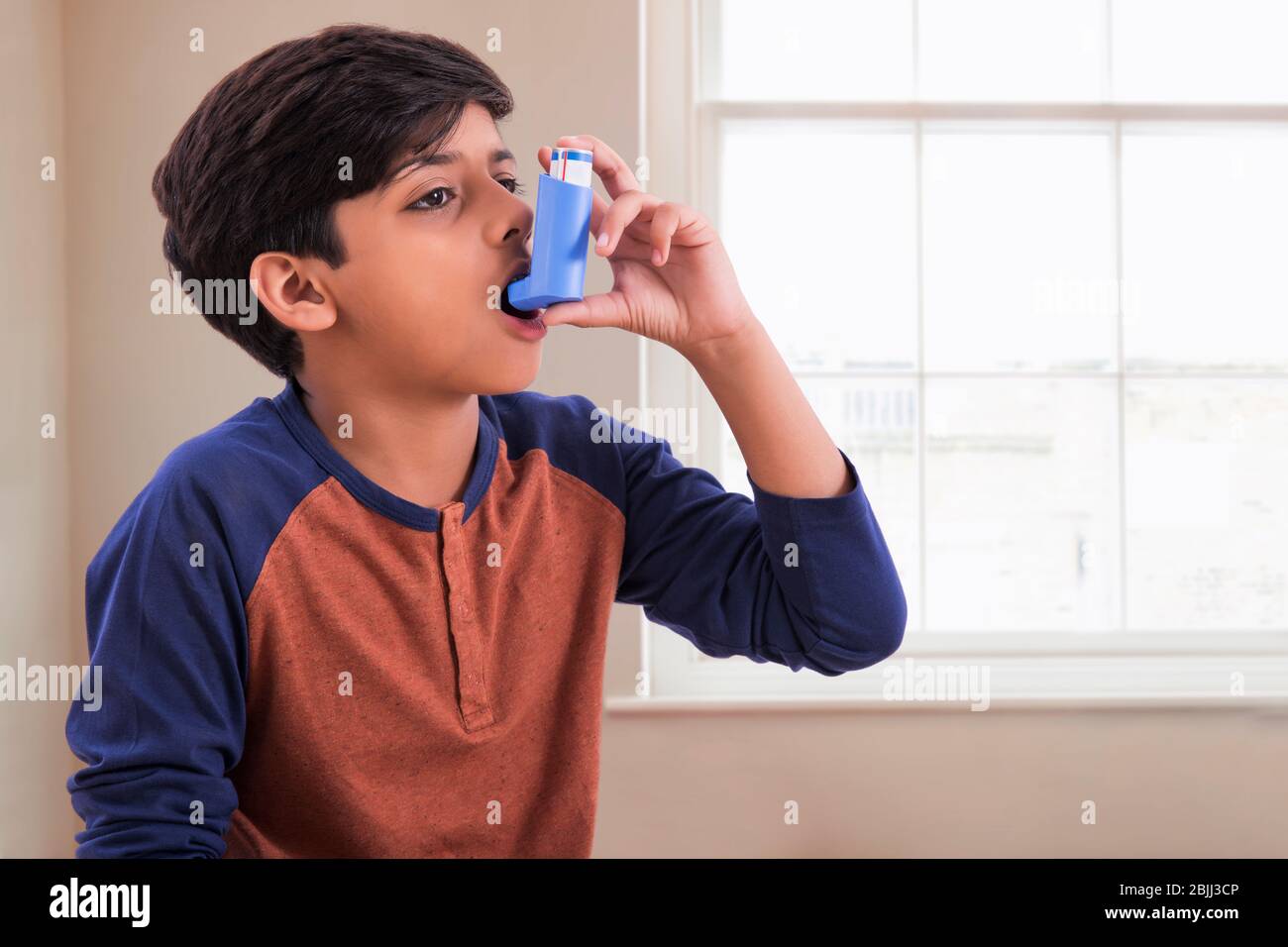 Young asthma patient taking an inhaler. (Children Stock Photo Alamy