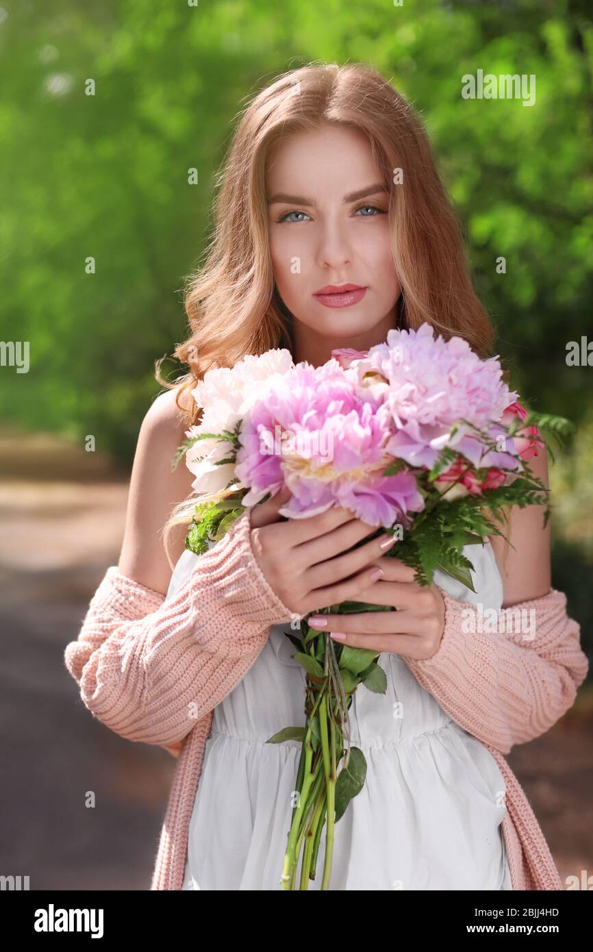 Woman with bouquet of peonies hi-res stock photography and images - Alamy