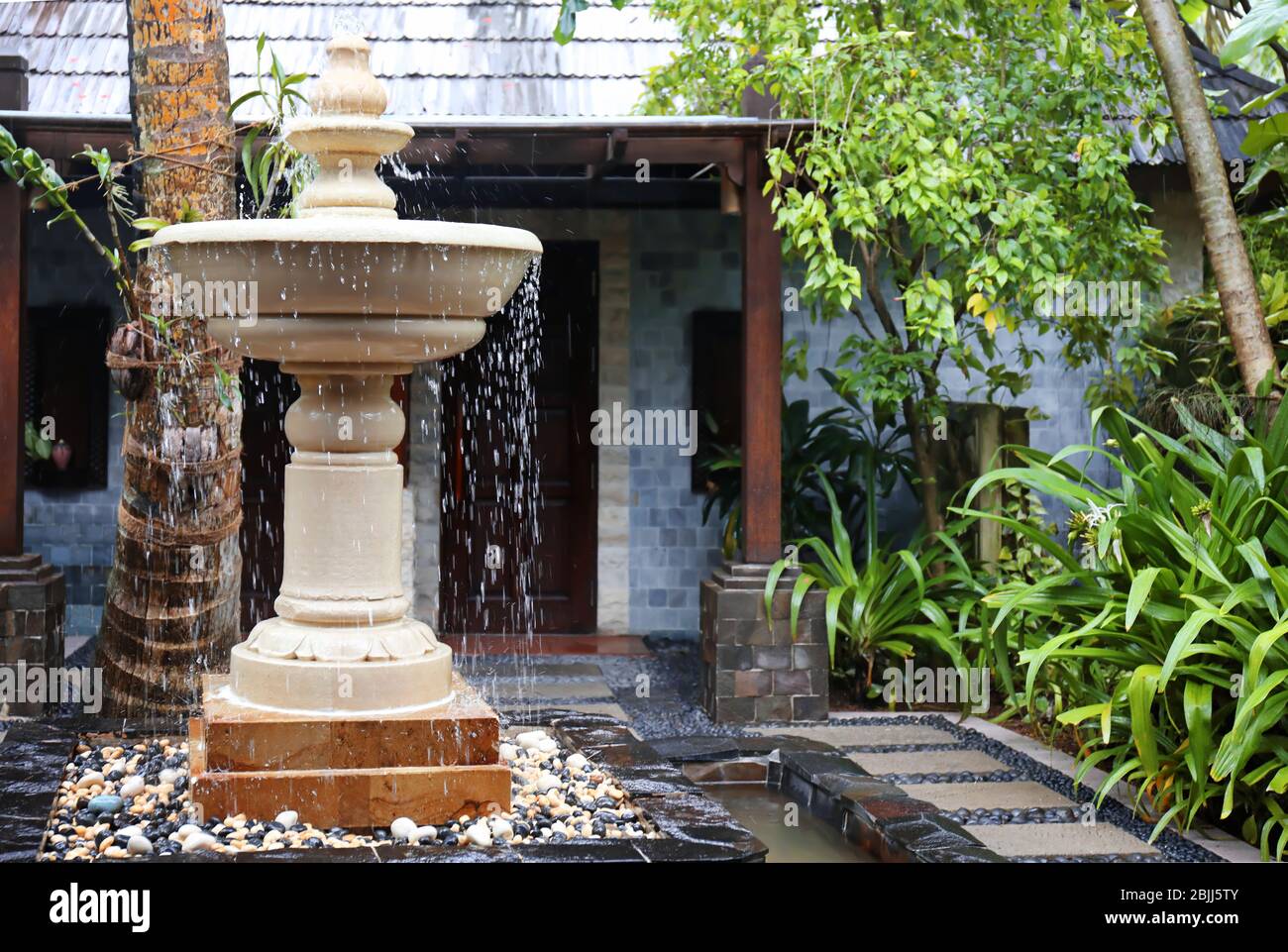 Beautiful fountain in garden Stock Photo - Alamy