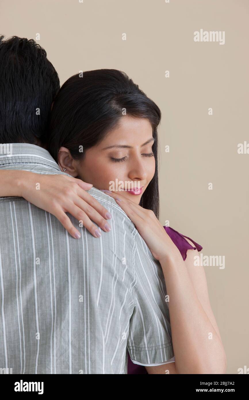 Woman hugging her husband Stock Photo - Alamy