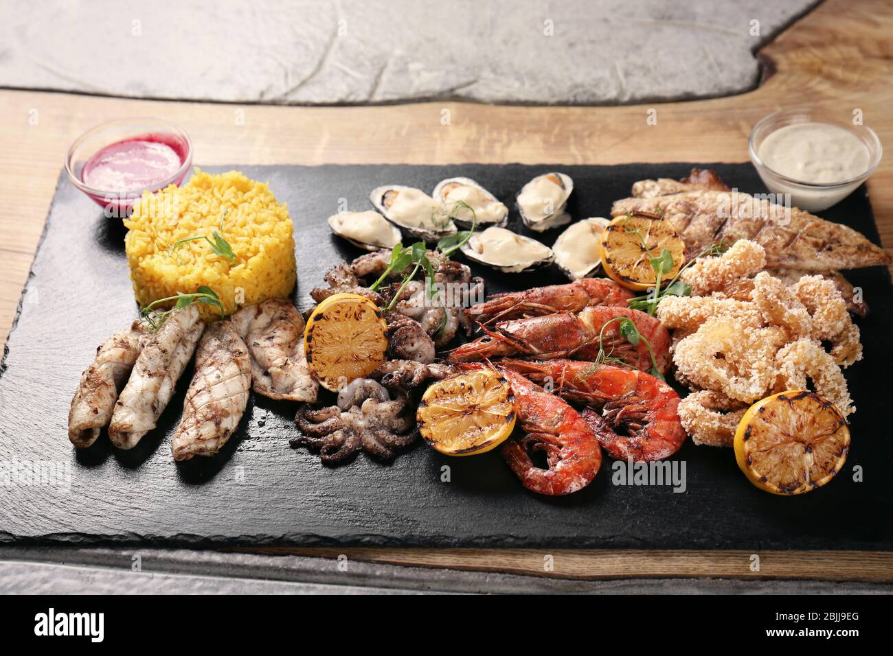 Slate Rice Variety of seafood with rice on slate plate Stock Photo - Alamy