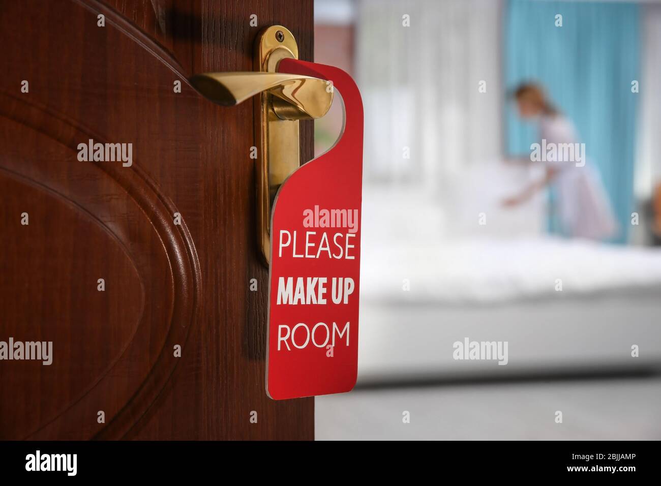 Open door with sign PLEASE MAKE UP ROOM on handle at hotel Stock Photo ...