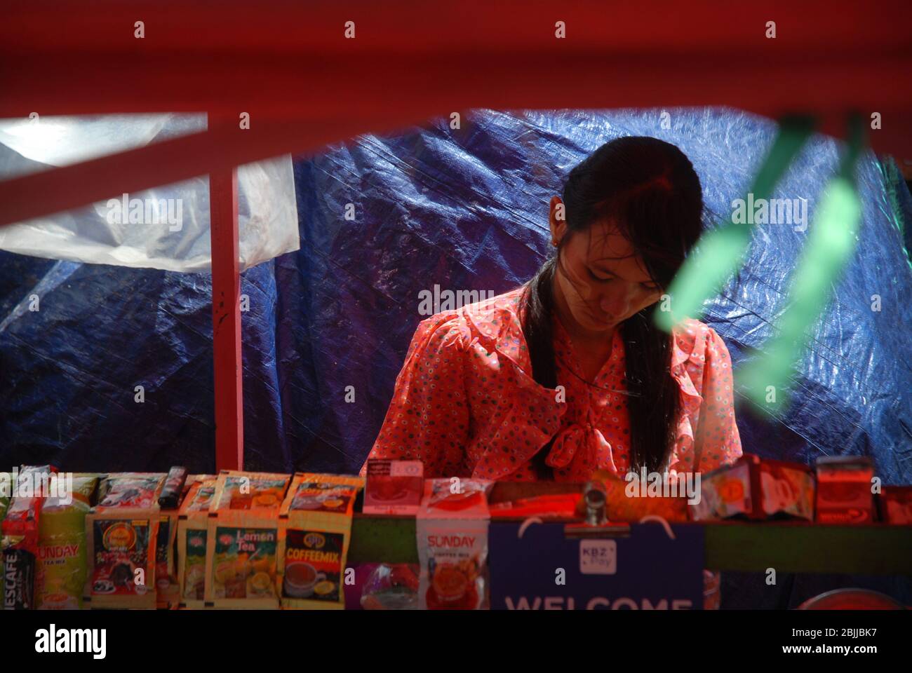 Lady selling small food items, Yangon, Myanmar, Asia. Stock Photo