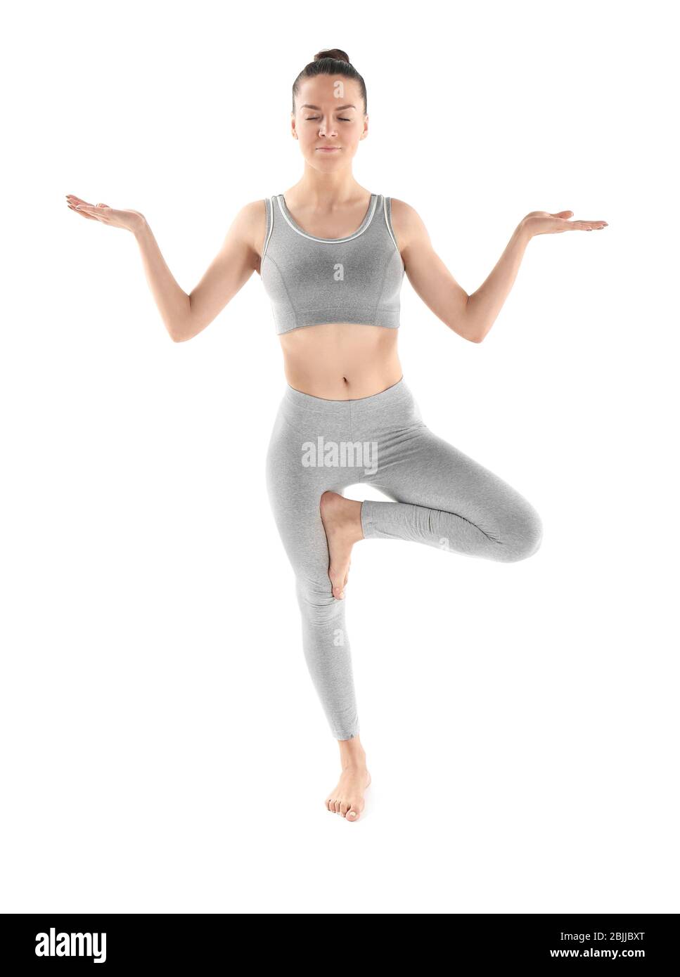 Young beautiful woman doing yoga pose on white background Stock Photo ...