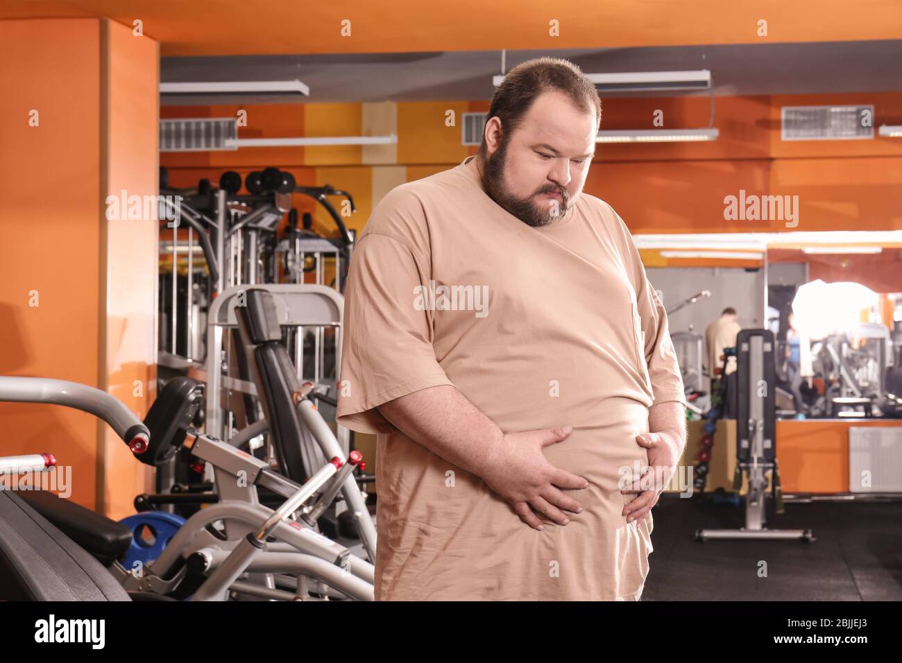 Overweight man in gym Stock Photo