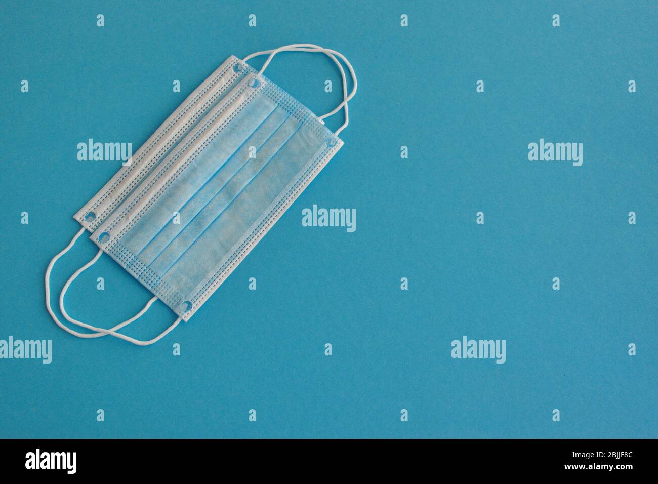 Medical face mask against the blue background Stock Photo - Alamy