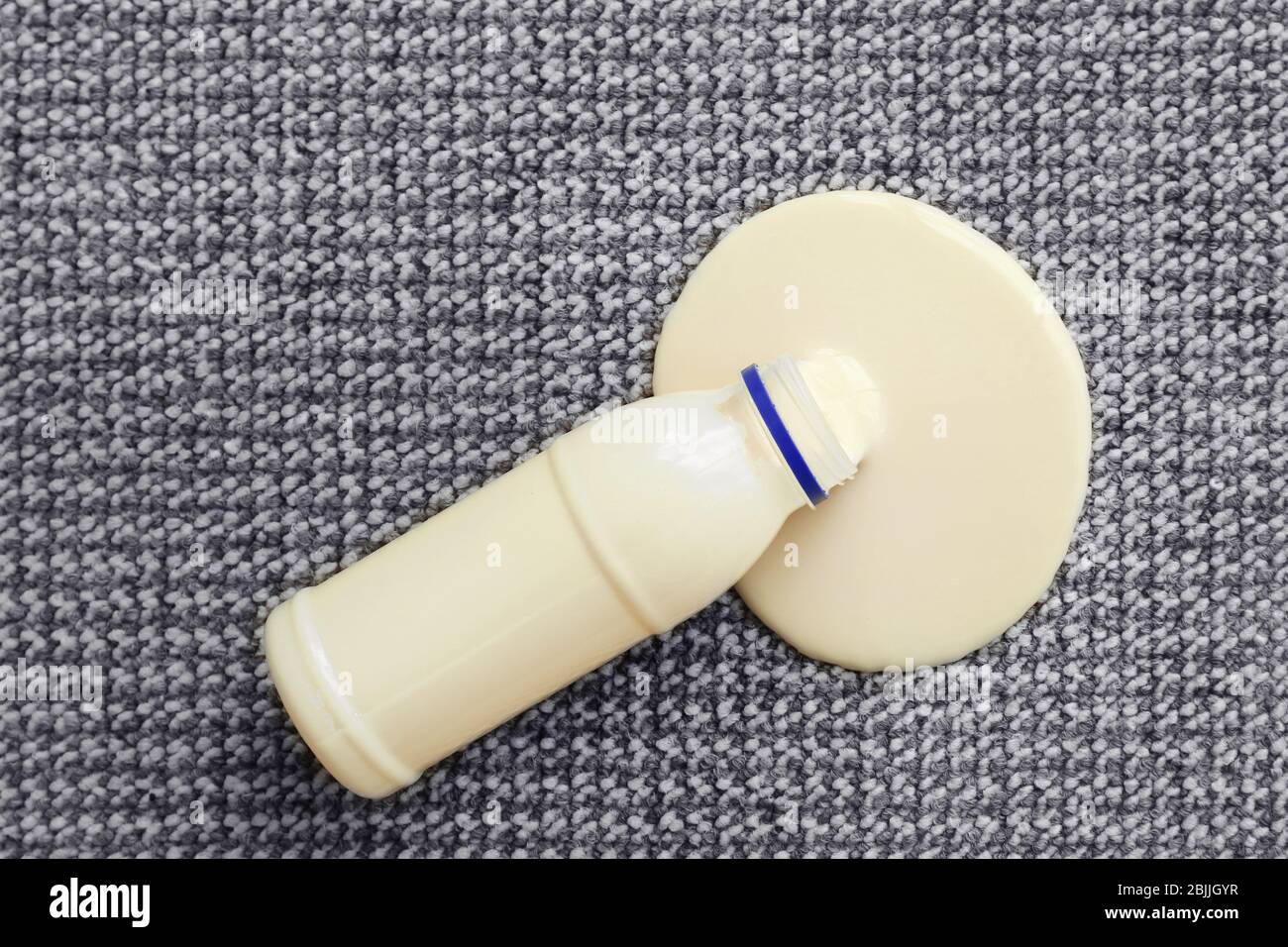 Bottle of yogurt spilled on carpet Stock Photo Alamy