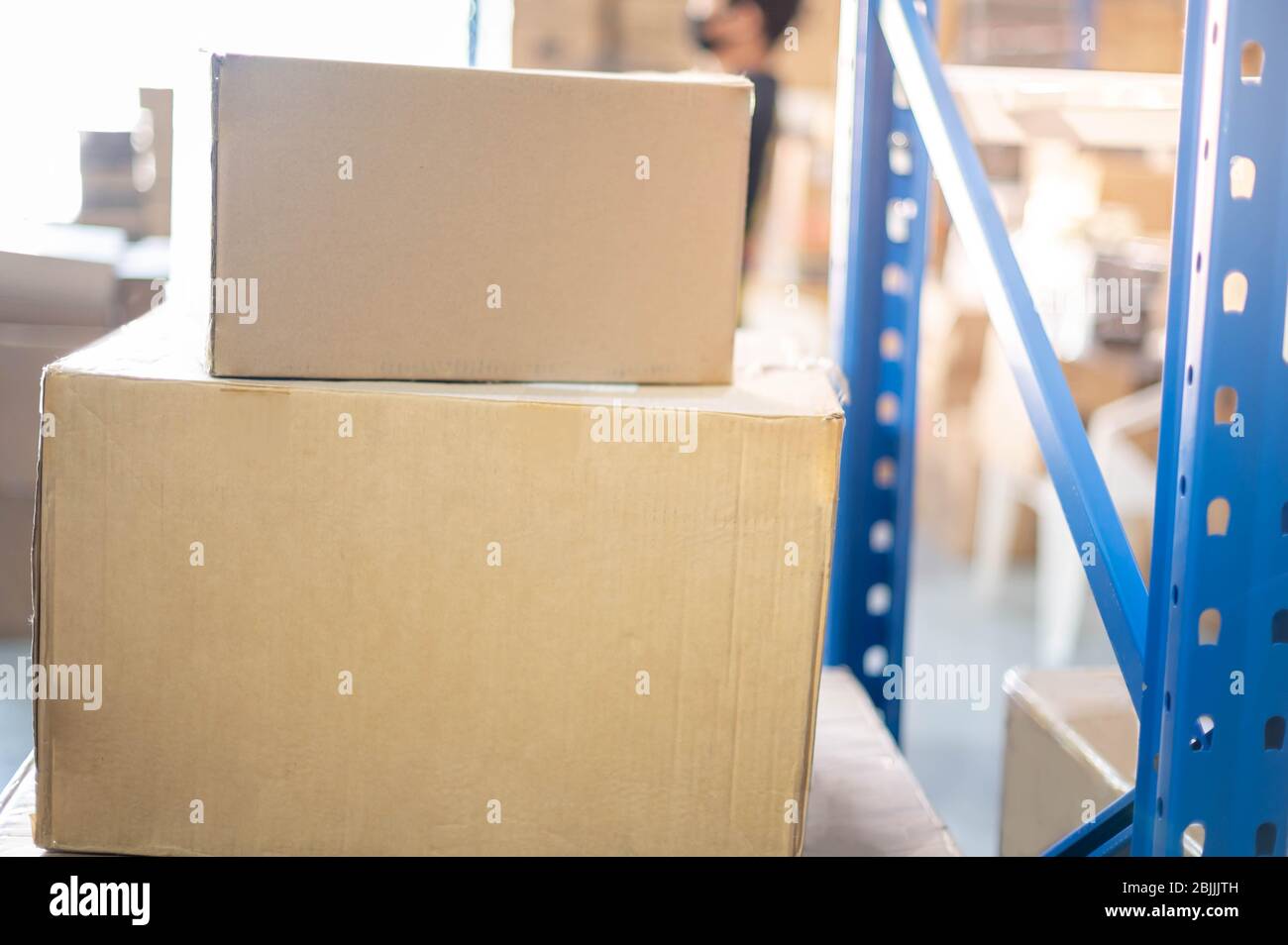 The cardboard box parcel prepare to put on the shelf or blue metal rack
