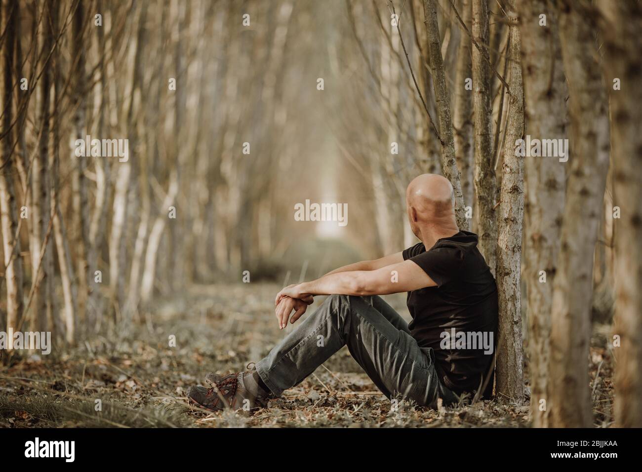 Sitting man with depression going through a rough patch in his life, suffering from mental exhaustion, anxiety, burnout Stock Photo