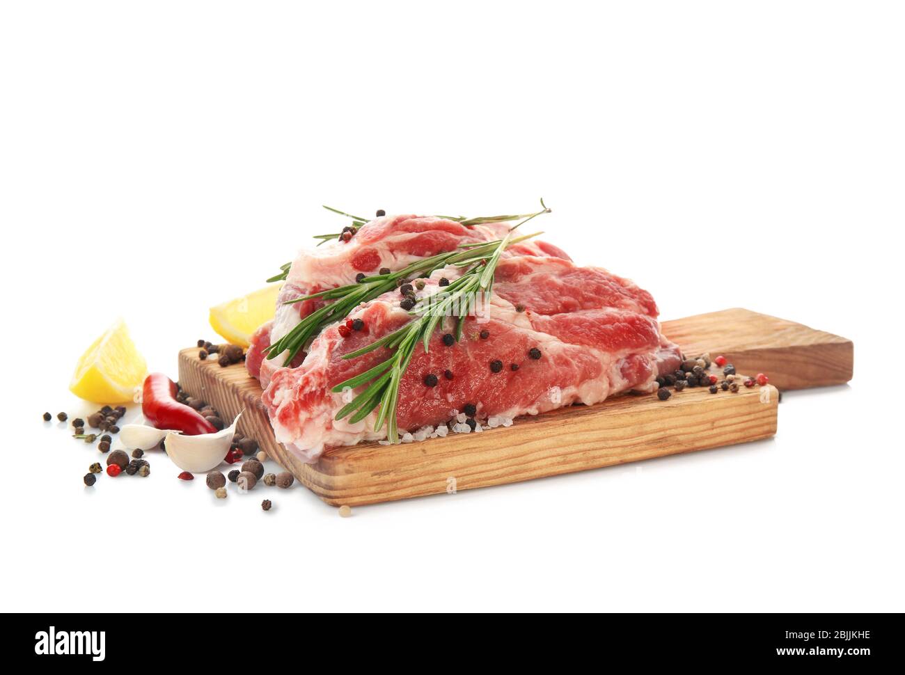 Wooden board with fresh raw meat and rosemary on white background Stock ...