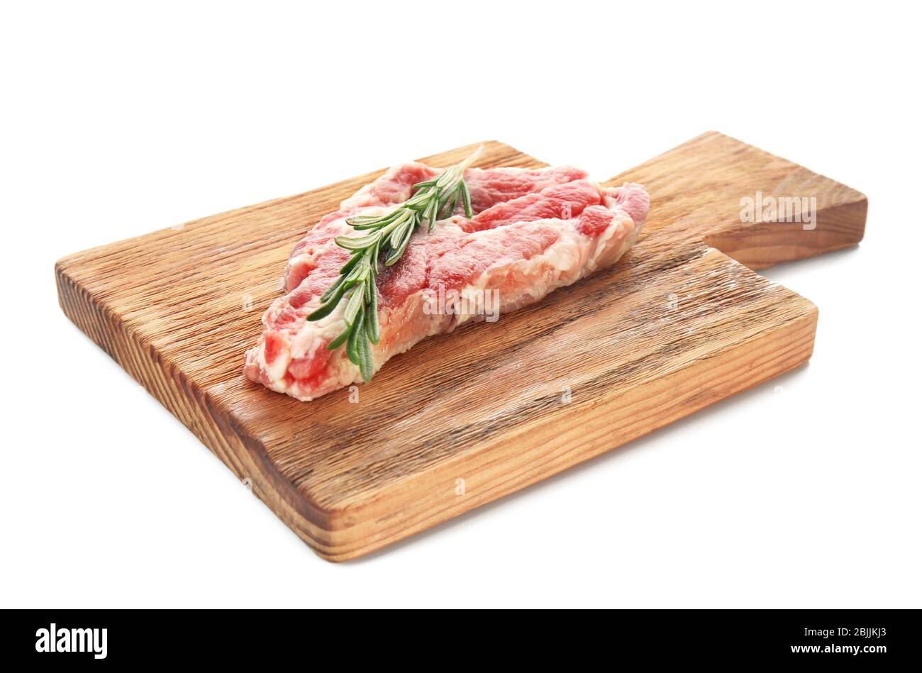 Wooden board with fresh raw meat and rosemary on white background Stock ...