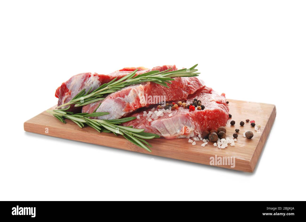 Wooden board with fresh raw meat and rosemary on white background Stock ...