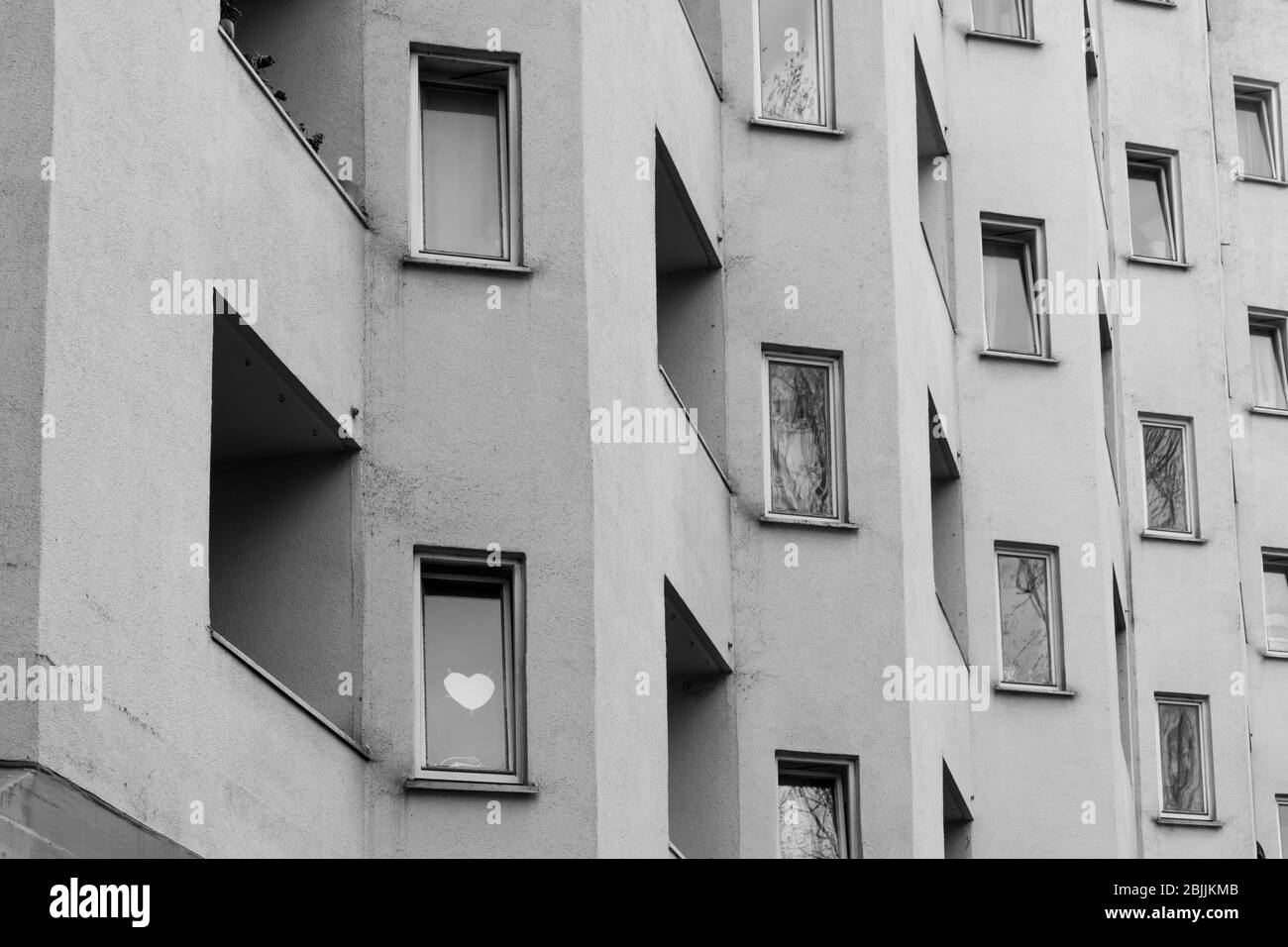 Heart behind the window of an apartment building Stock Photo