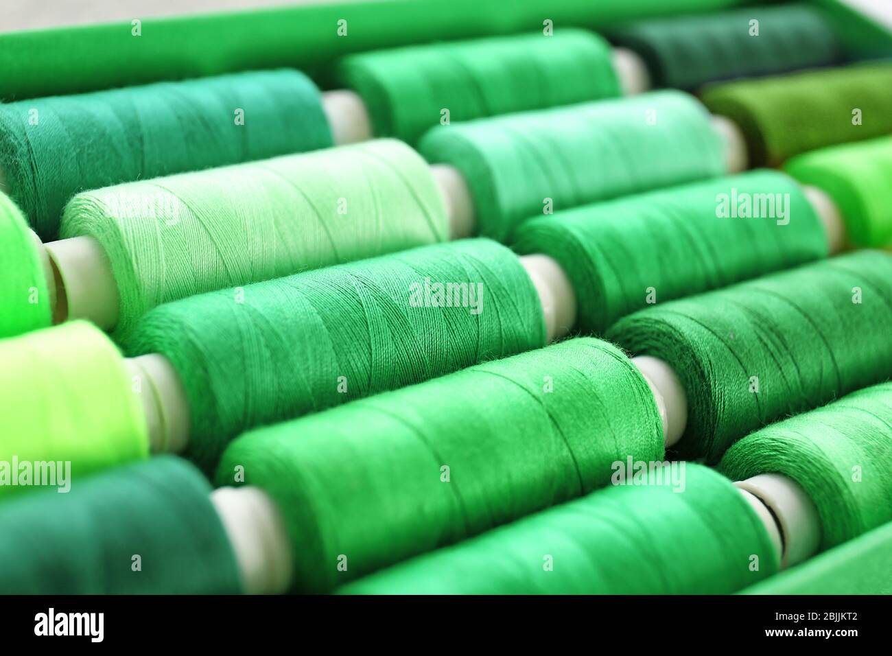 Green sewing threads of different shades Stock Photo Alamy
