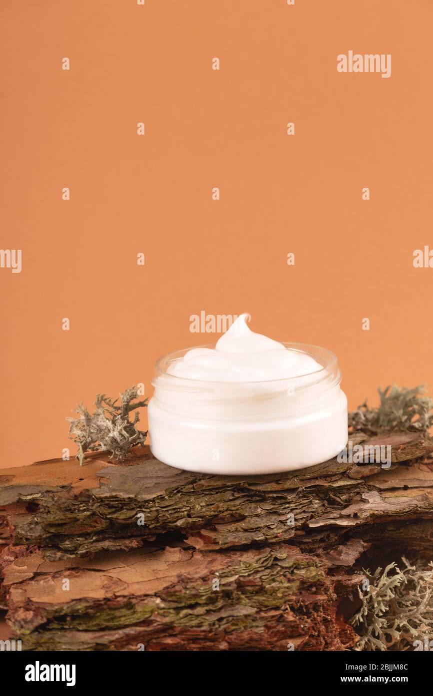 Cream for the face on the bark of a tree. Natural care concept Stock