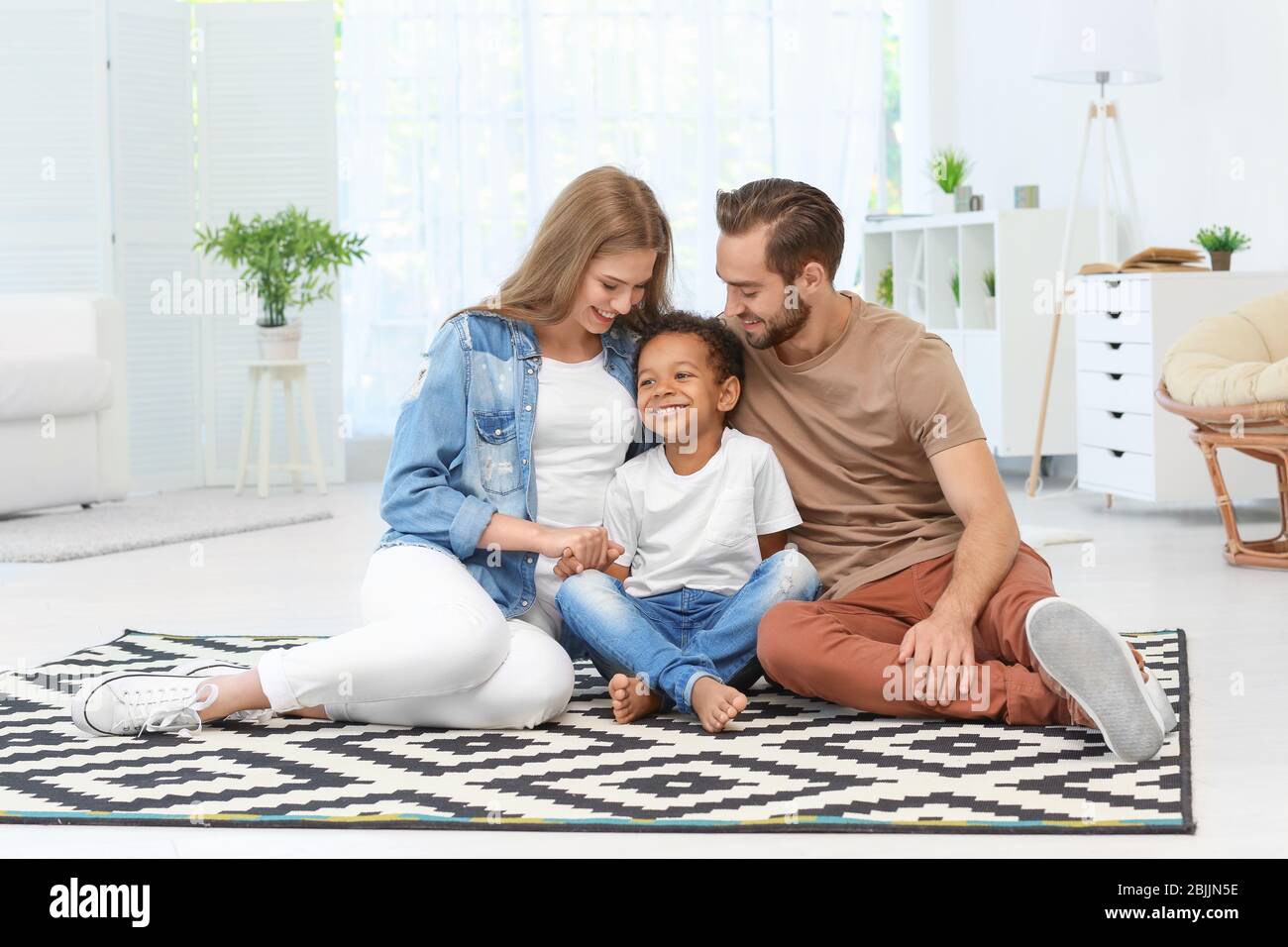African boy sitting on floor hi-res stock photography and images - Alamy