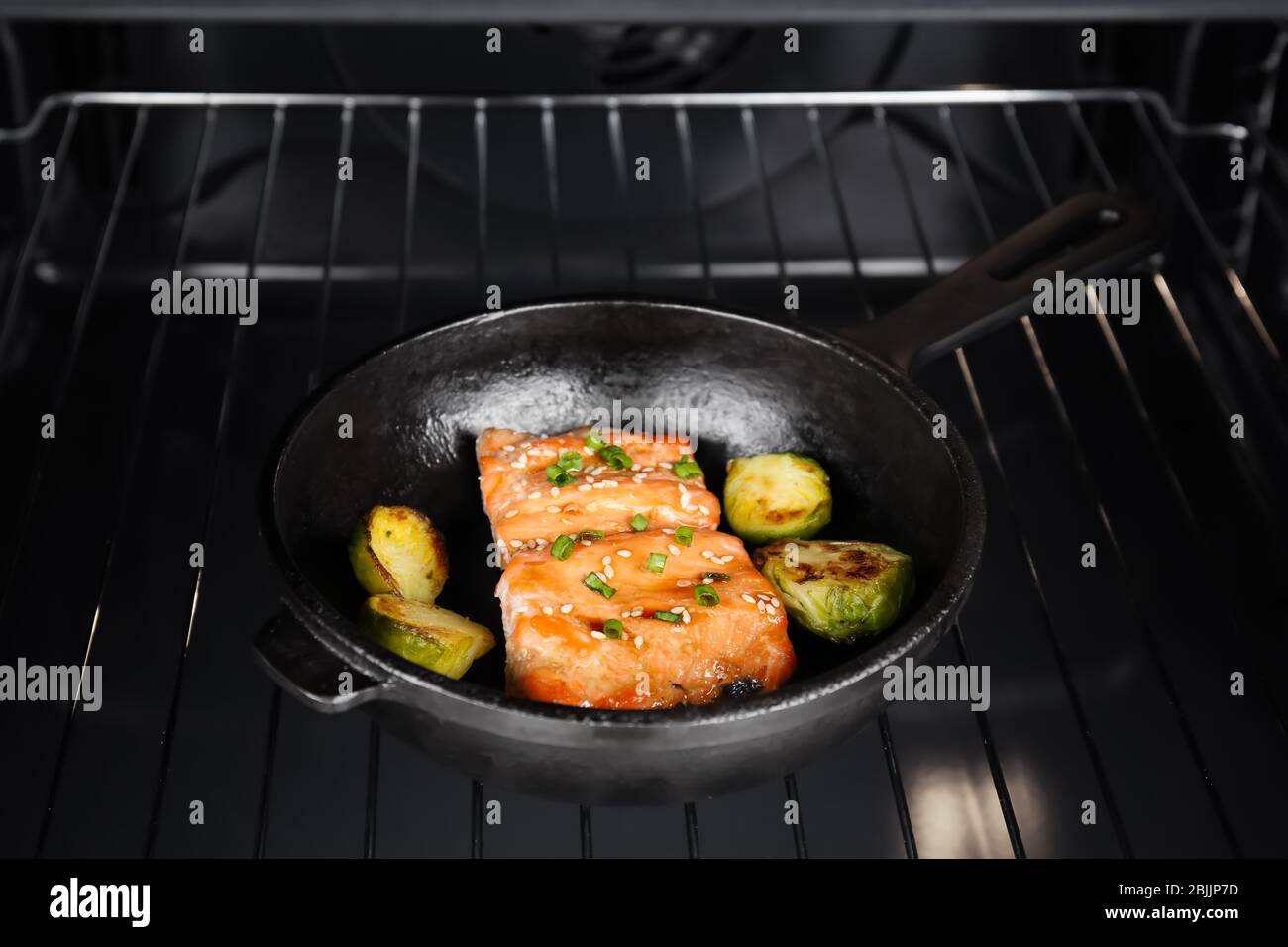 Frying pan with tasty fish fillets in oven Stock Photo Alamy