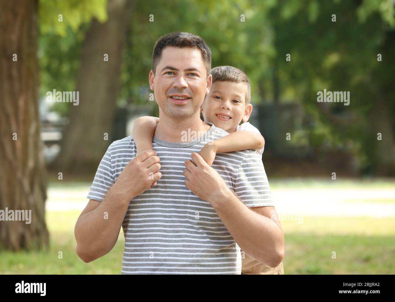 Happy father and son in park Stock Photo - Alamy