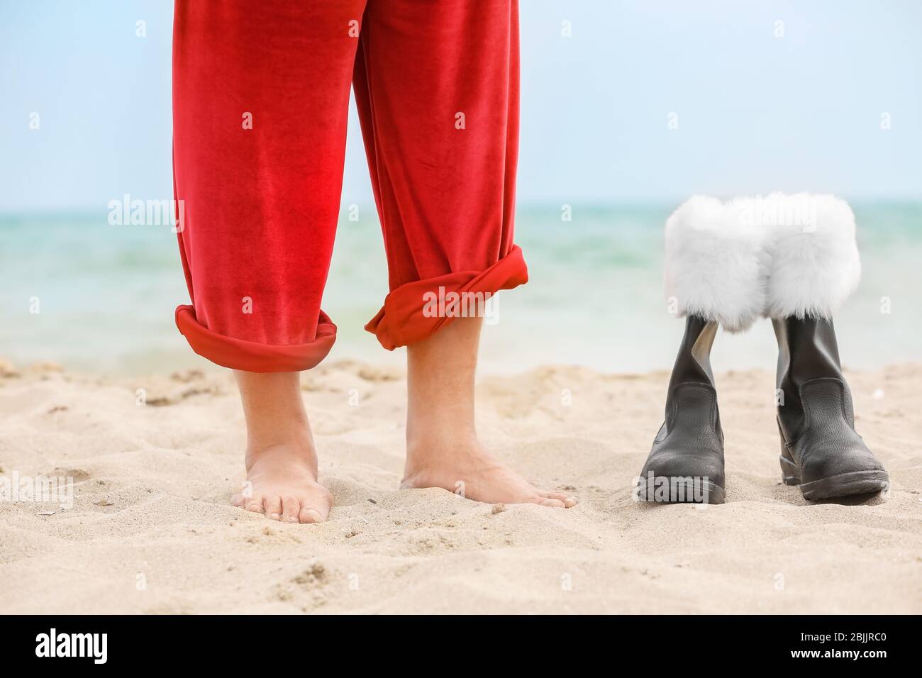 Barefoot Santa Claus and boots on beach Stock Photo Alamy