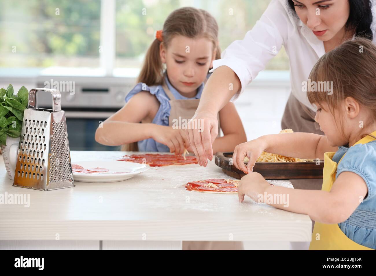 Children and teacher in kitchen during cooking classes Stock Photo - Alamy