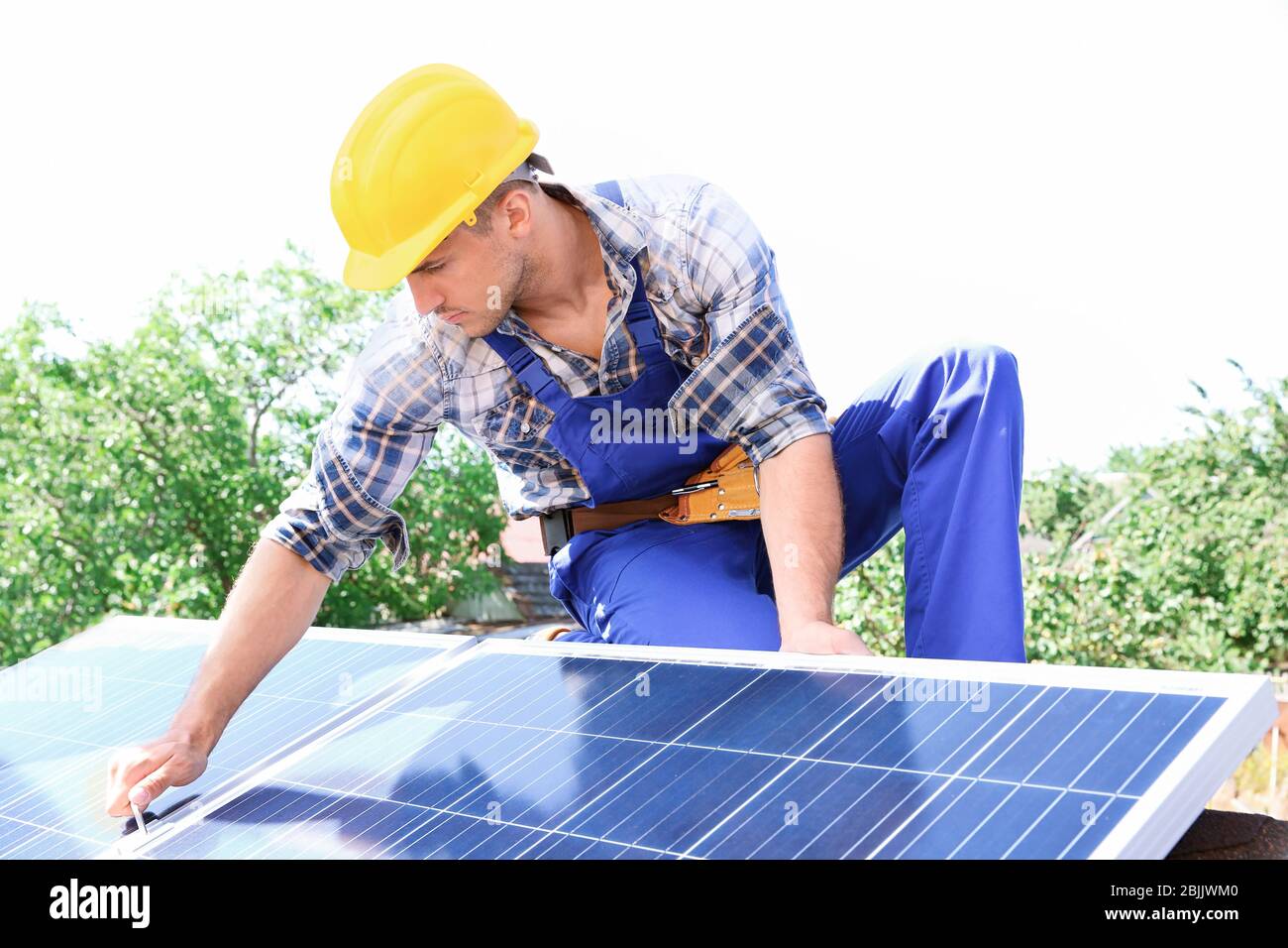 Worker installing solar panels outdoors Stock Photo Alamy