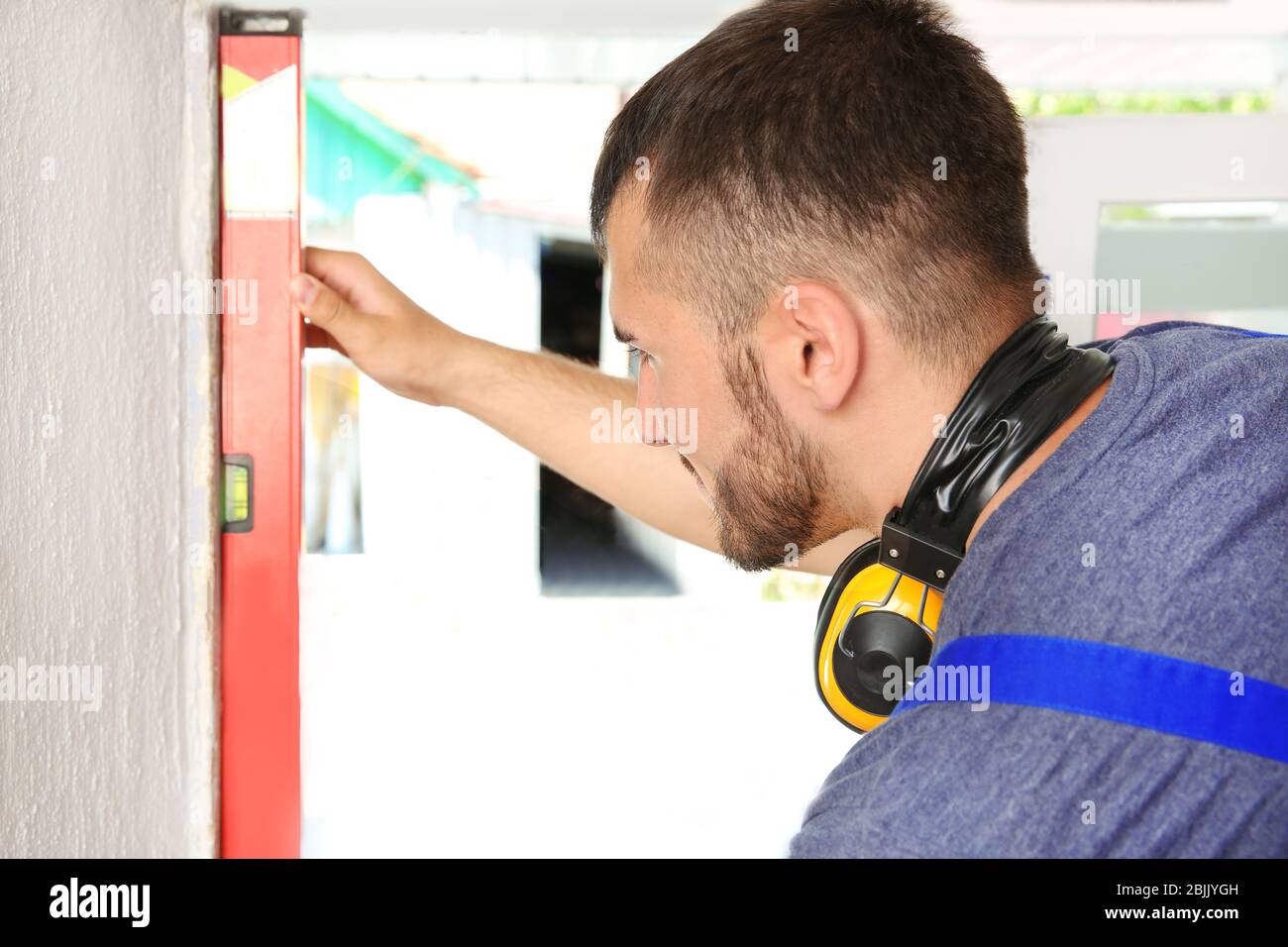 Worker repairing window in flat Stock Photo