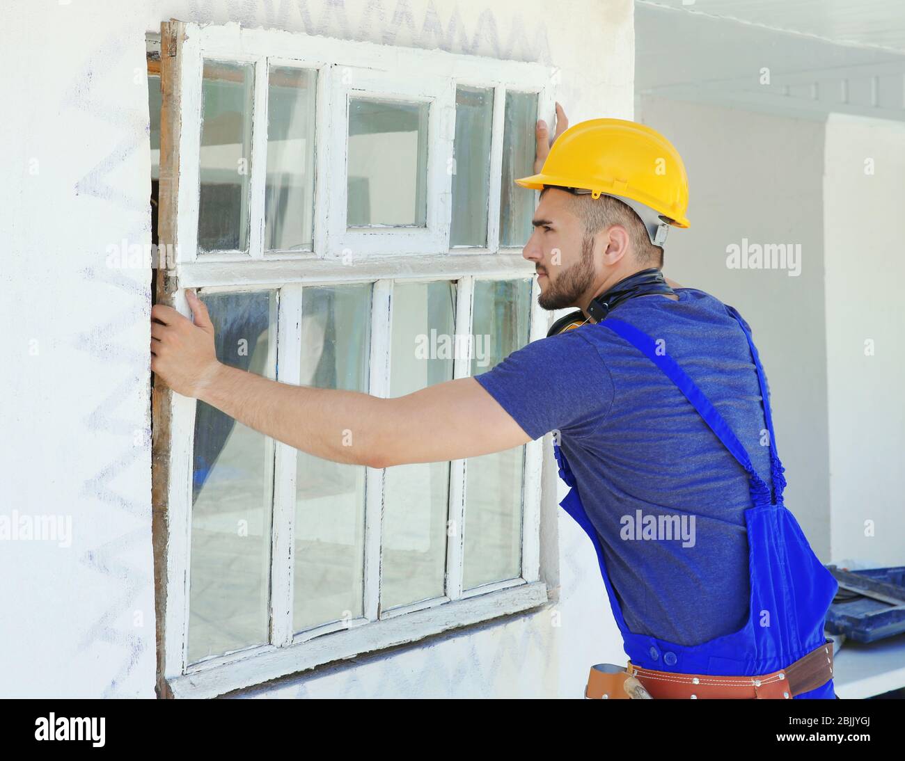 Worker removing old window in flat Stock Photo - Alamy