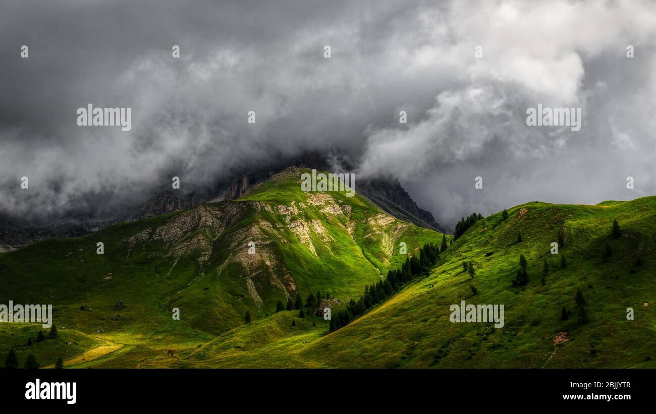 Rays of Sun over the mountains with storm clouds in the sky Stock Photo
