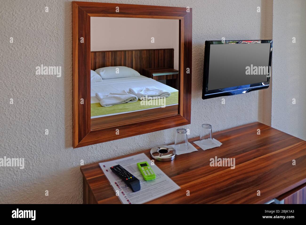 Mirror and wooden commode in bedroom Stock Photo - Alamy