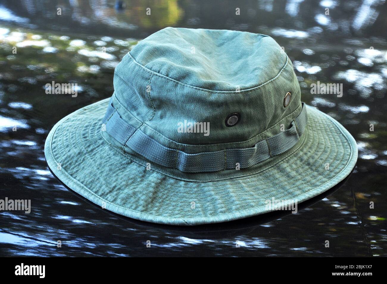 Green military boonie hat on black 