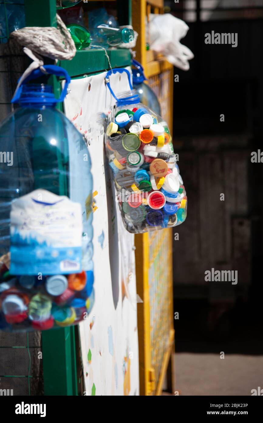 Sorting garbage. Plastic bottle caps. Recycling. The container for collecting plastic. Eco trend