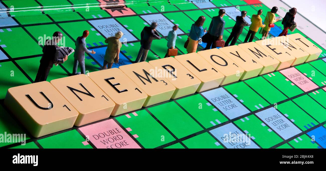 Unemployment queue,unemployed concept,miniature figurines on a scrabble board background Stock Photo