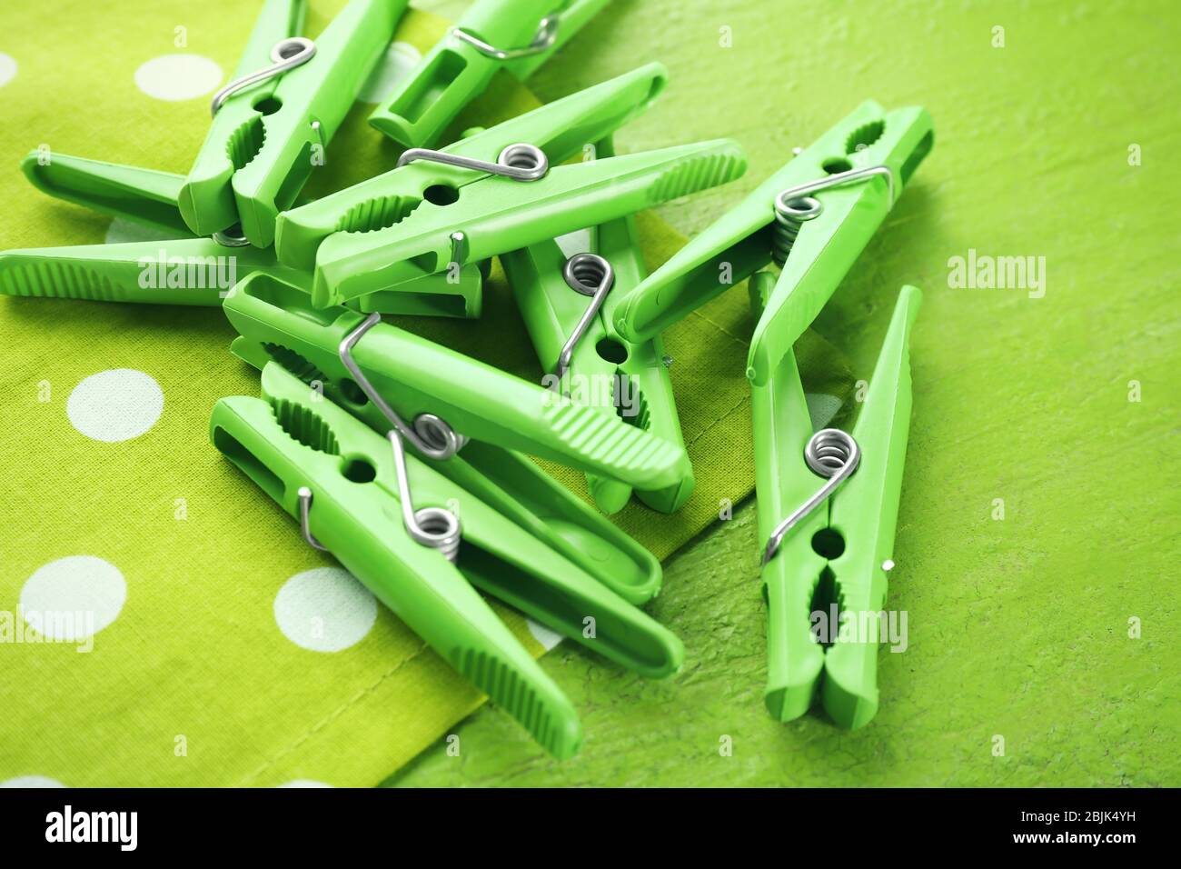 Green clothes pins on color table Stock Photo