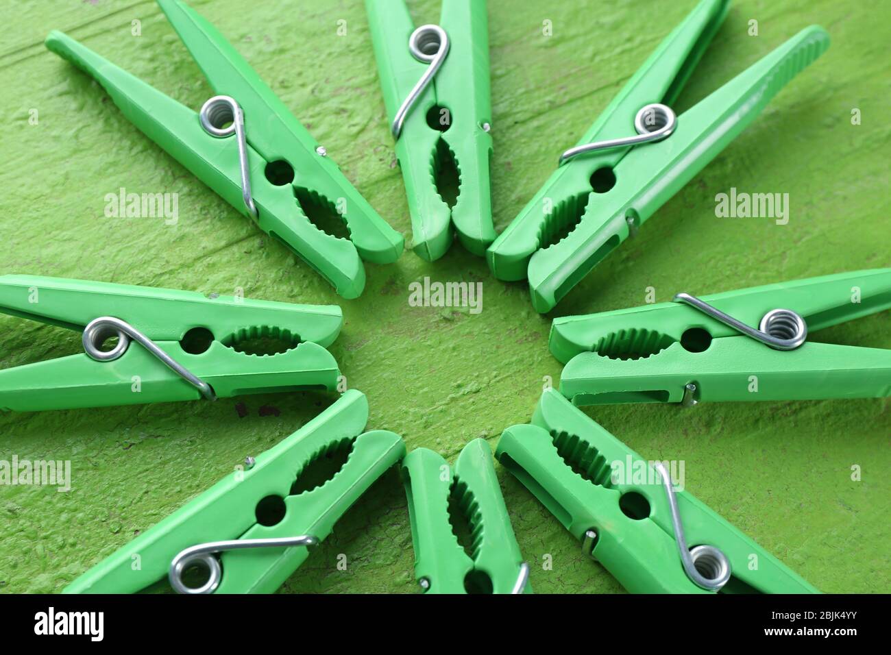 Green clothes pins on color table Stock Photo
