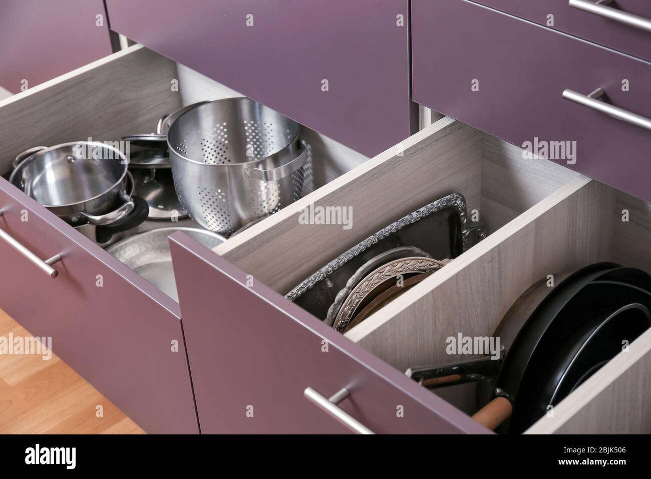 Different kitchenware in drawers Stock Photo - Alamy