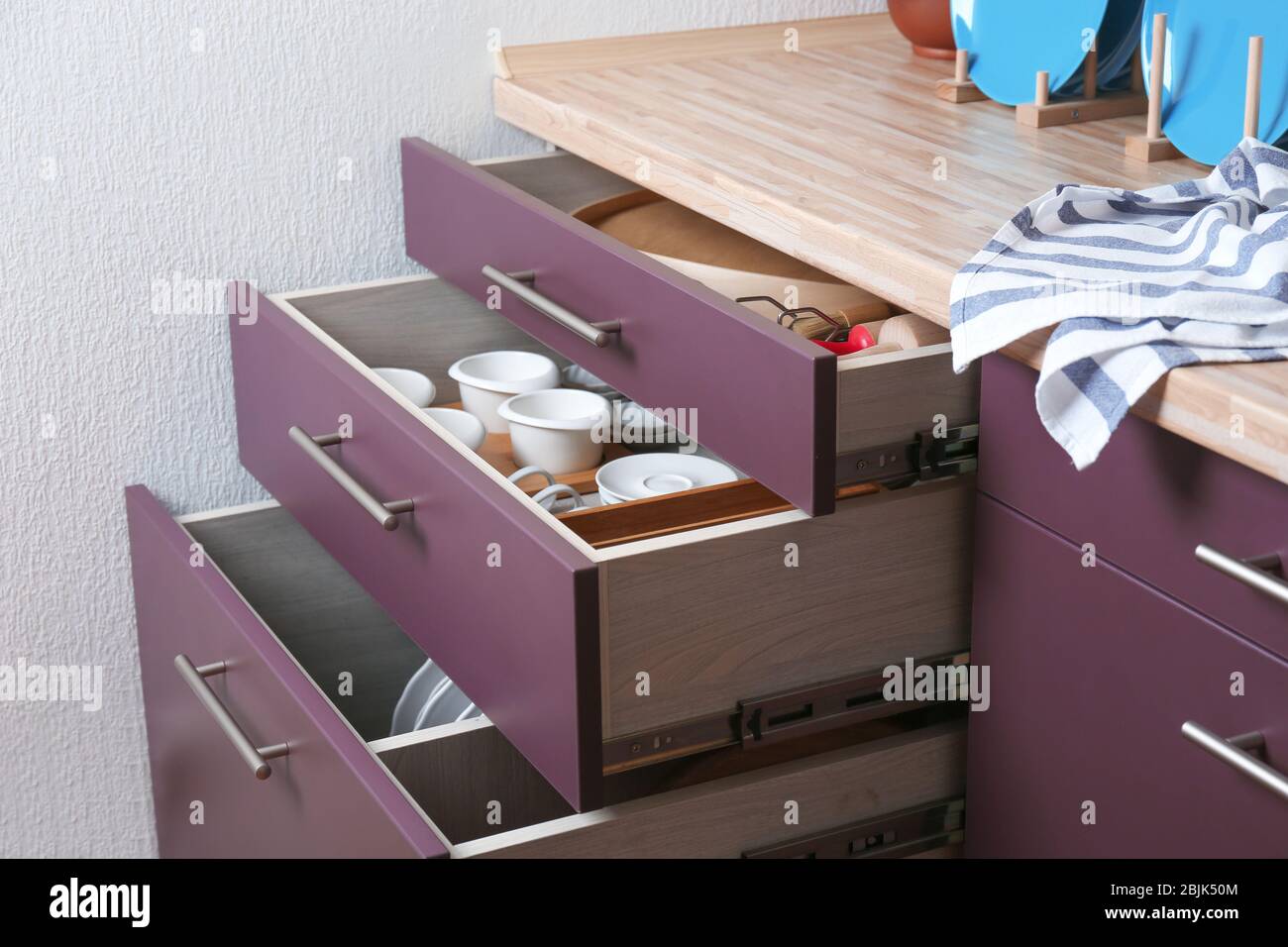 Different kitchenware in drawers Stock Photo - Alamy