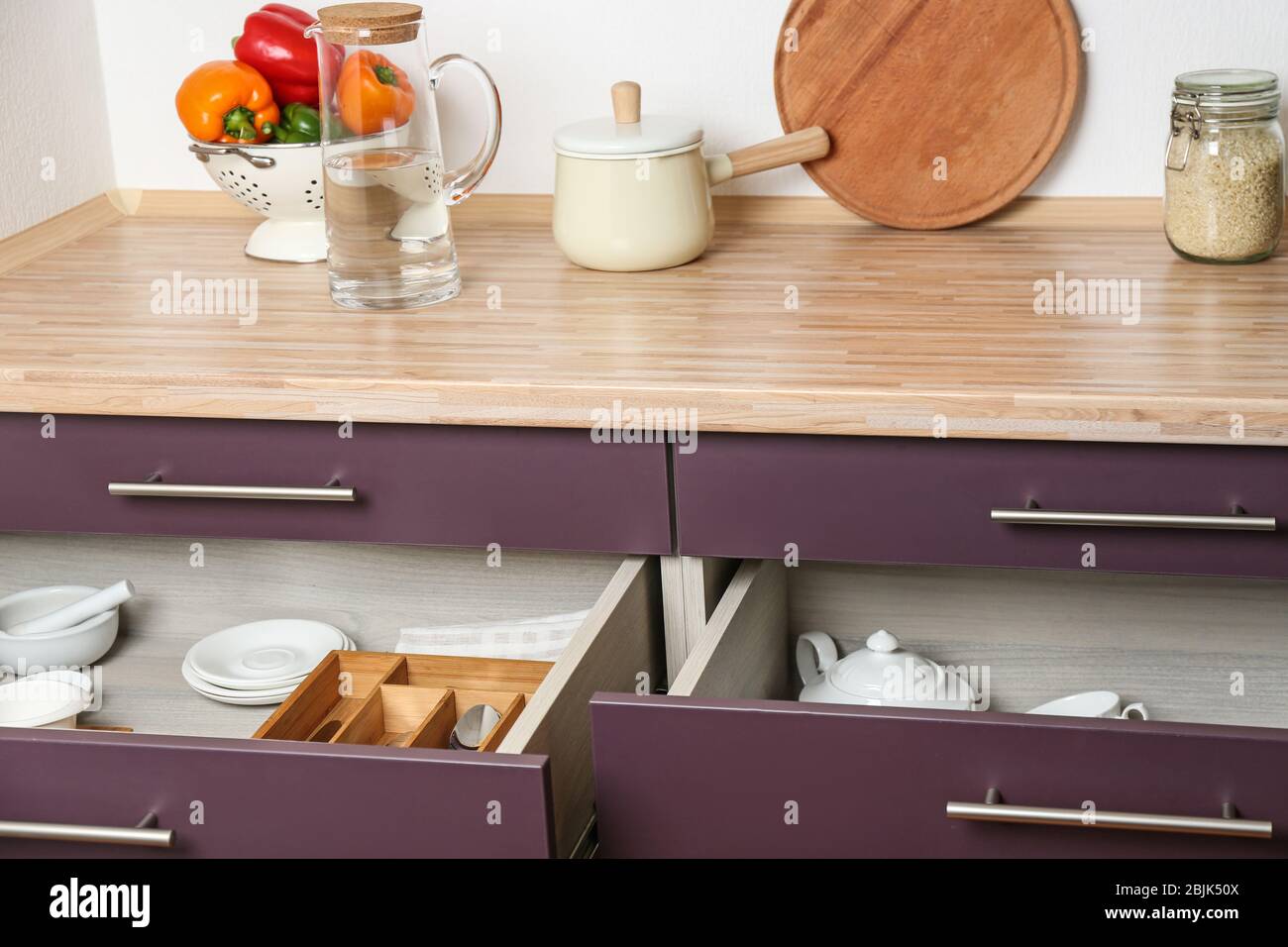 Different kitchenware in drawers Stock Photo - Alamy
