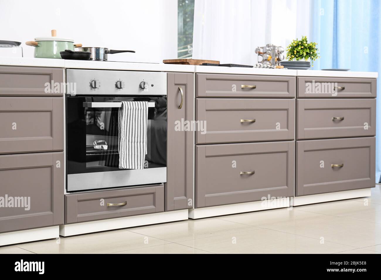 Modern kitchen furniture with electric stove Stock Photo - Alamy