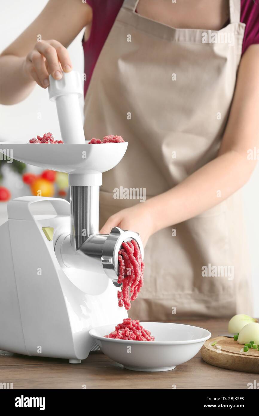 https://c8.alamy.com/comp/2BJK5F3/woman-using-grinder-for-preparation-of-minced-meat-in-kitchen-2BJK5F3.jpg