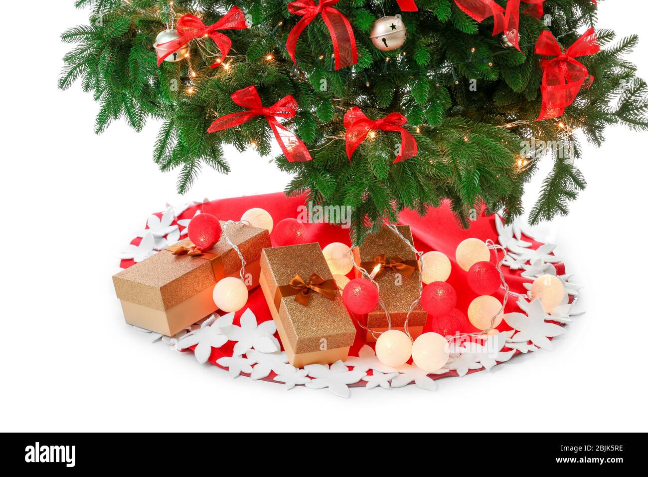 Beautiful Christmas tree with skirt and gifts on white background Stock ...