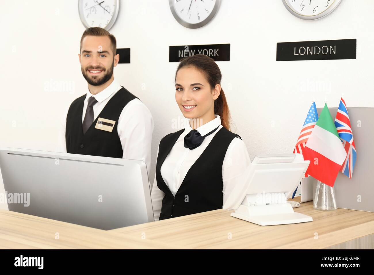 Two hotel receptionists at workplace Stock Photo Alamy